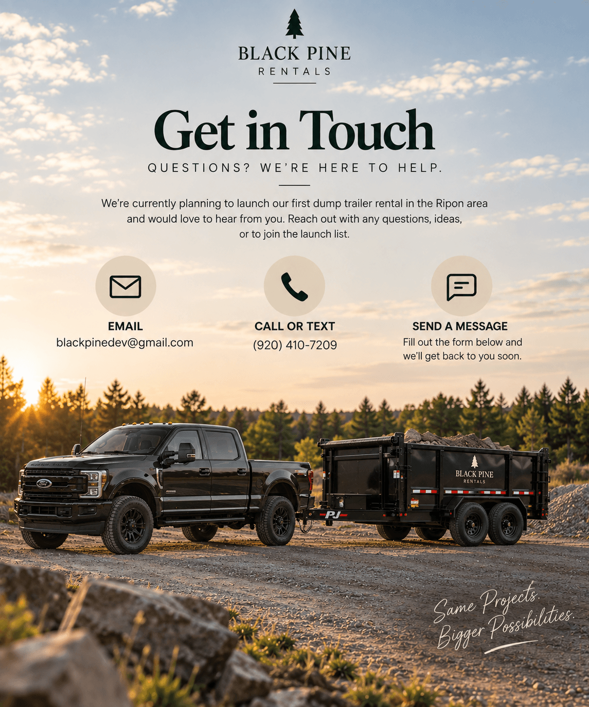 Black Ford truck towing a dump trailer filled with rocks against a sunset forest background.